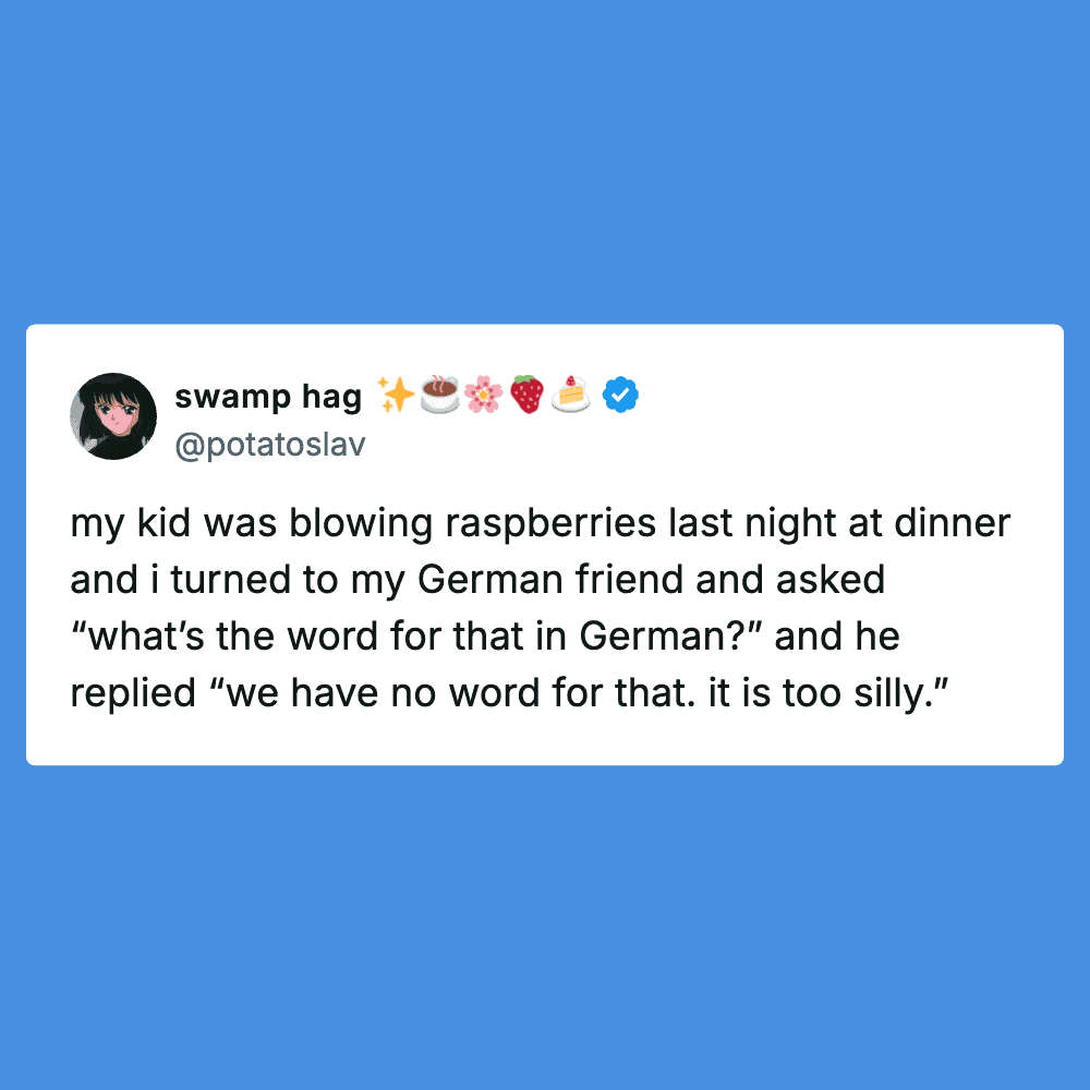 Child blowing raspberries at dinner, humorous family moment.