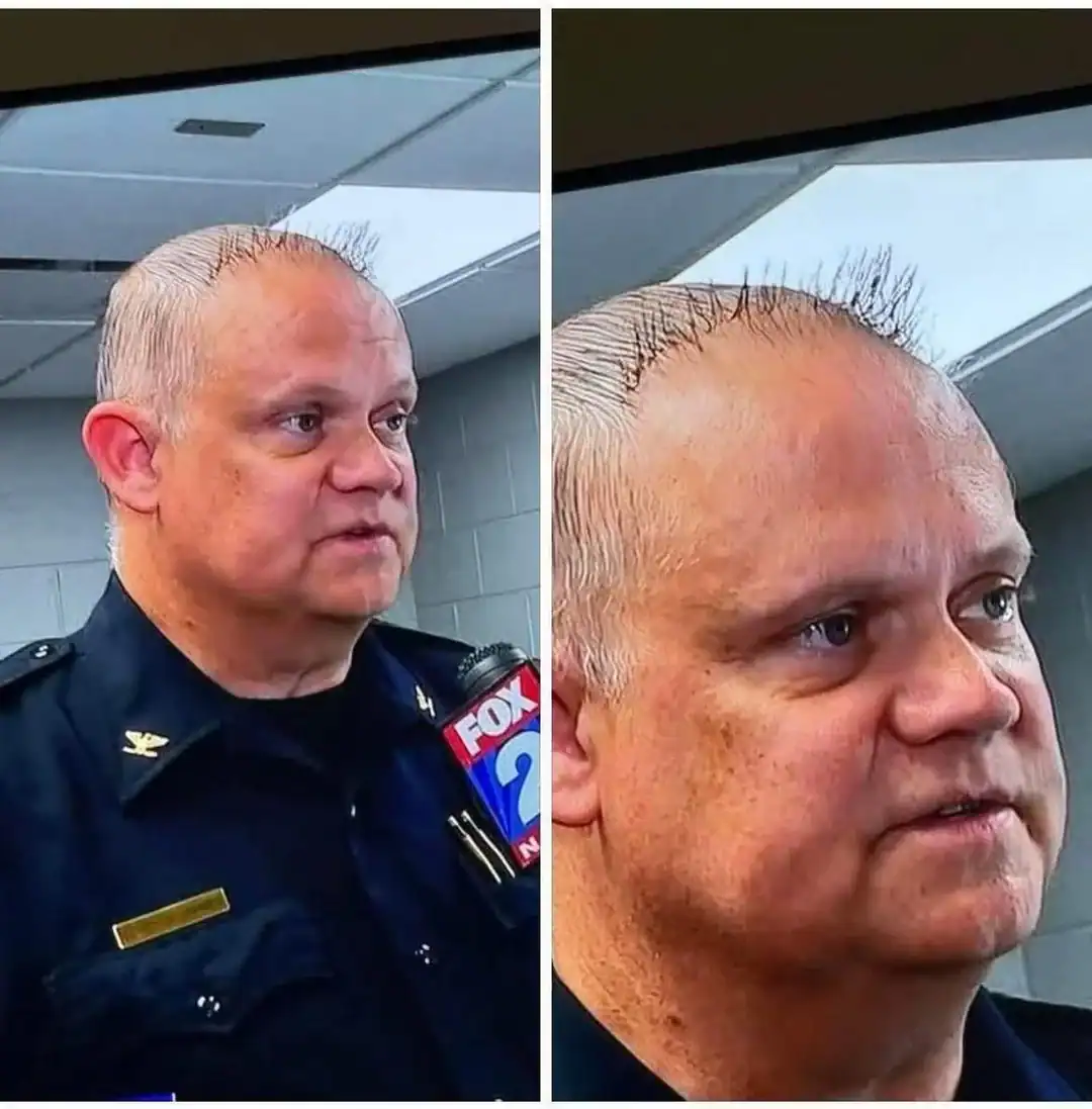 Police officer with short, wet hair speaking to the media.