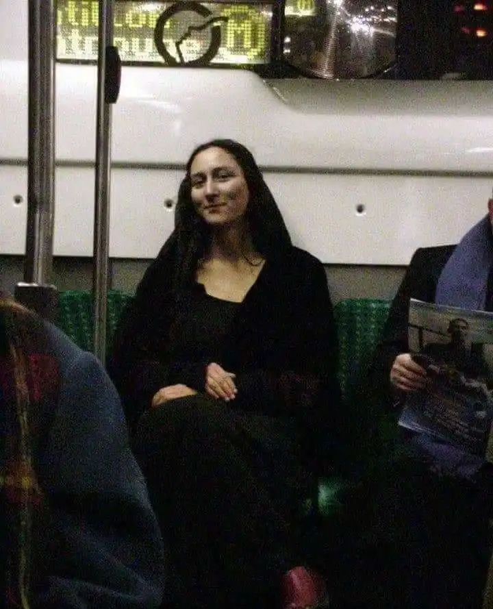 A woman sitting on a bus with her eyes closed and a slight smile.