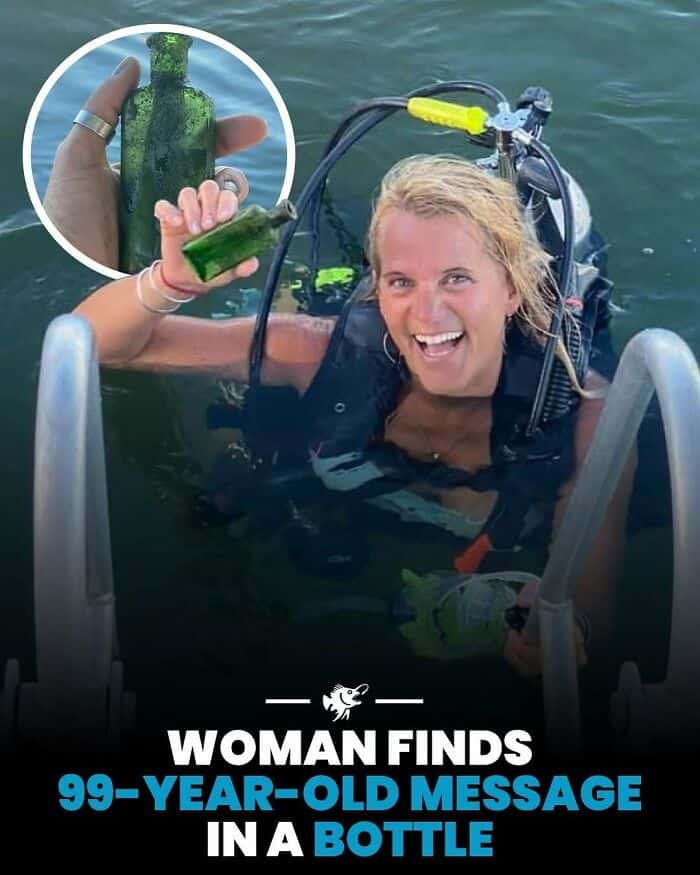 Woman in water holding a bottle with a message inside, smiling and excited.