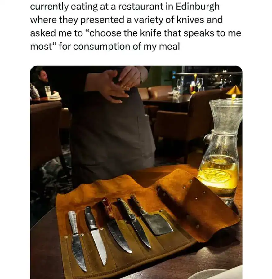 Collection of various knives on a leather roll at a restaurant in Edinburgh.