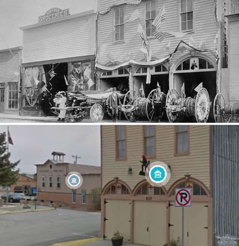 Historical black and white photo of a 19th-century storefront with horse-drawn wagons.