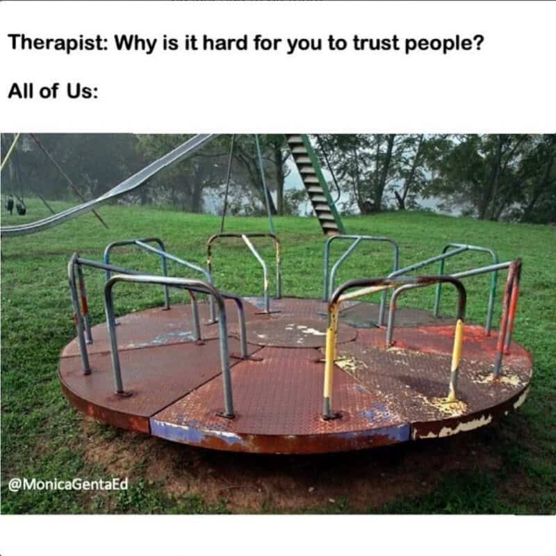 Empty rusty merry-go-round with a slide in the background, caption about trust issues.