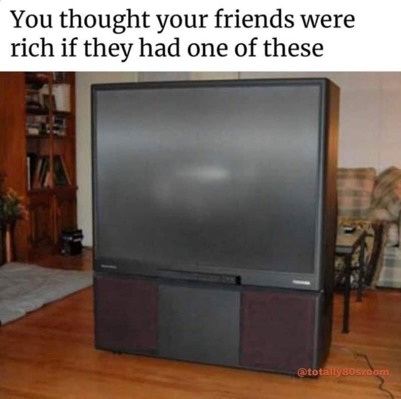 A large flat-screen TV with a wooden cabinet base in a living room.