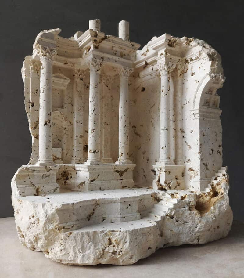 Ancient marble sculpture fragment with columns and architectural details.