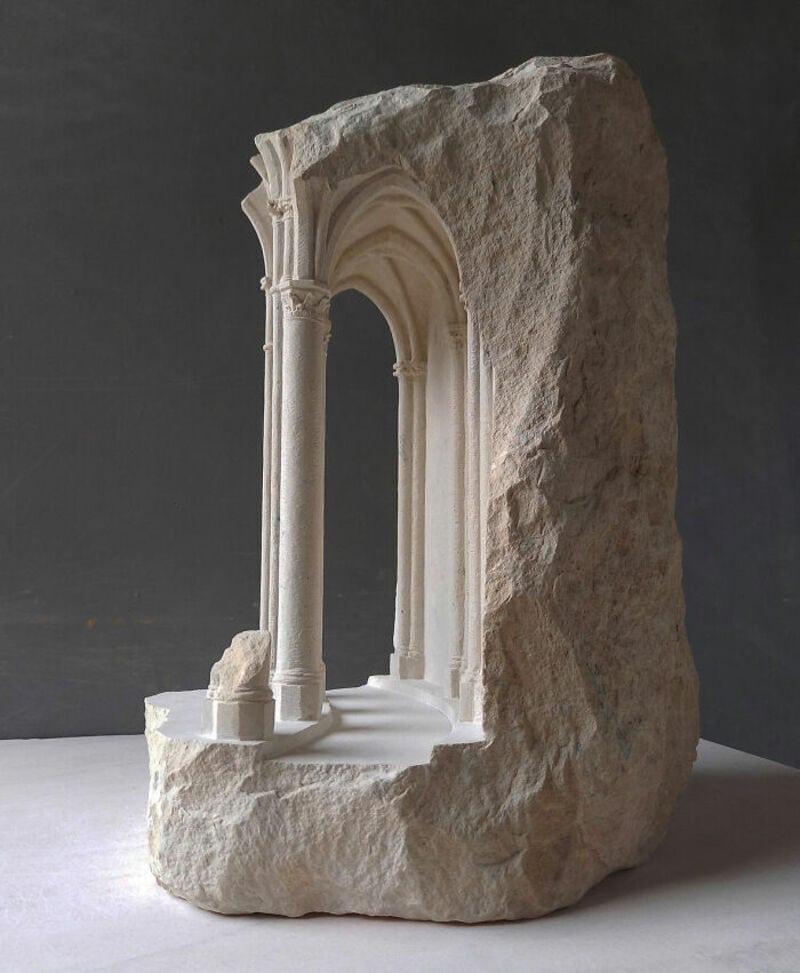 Ancient marble sculpture fragment with classical architectural details and columns.