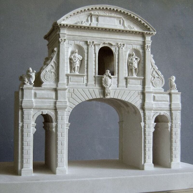 Marble architectural sculpture with statues and detailed carvings.