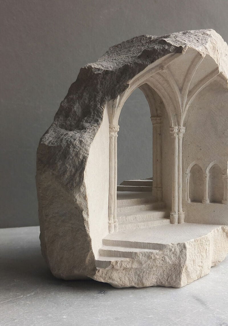Sculpture of a stone archway with steps, carved from a single piece of marble.