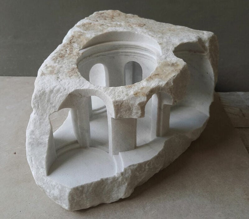 Marble sculpture of a classical building with columns and a domed roof.