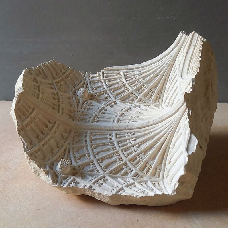 Detailed marble sculpture fragment with intricate architectural patterns.