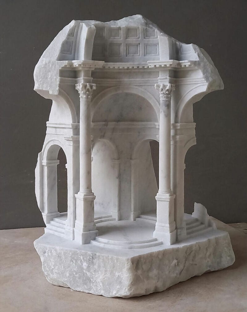 Marble sculpture of a classical architectural structure with columns and arches.
