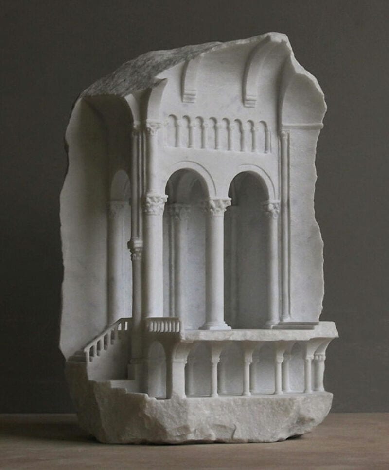 Marble sculpture fragment with arches and columns from classical architecture.