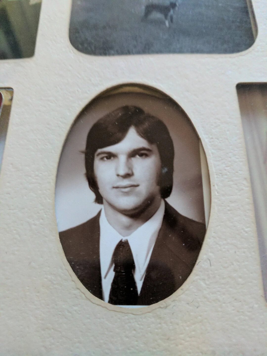 Black and white photo of a young man in a suit and tie.