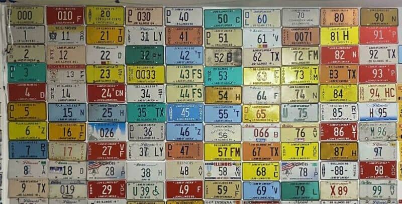 Collection of vintage license plates from various states and years.