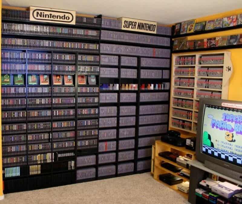 A large collection of video games on shelves, including Nintendo and Super Nintendo titles, with a 8.