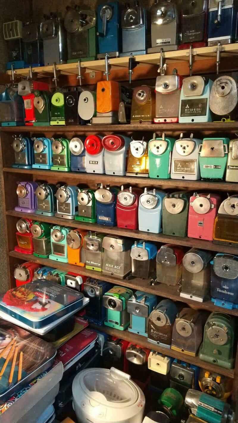 Collection of vintage cameras and film cameras on shelves.
