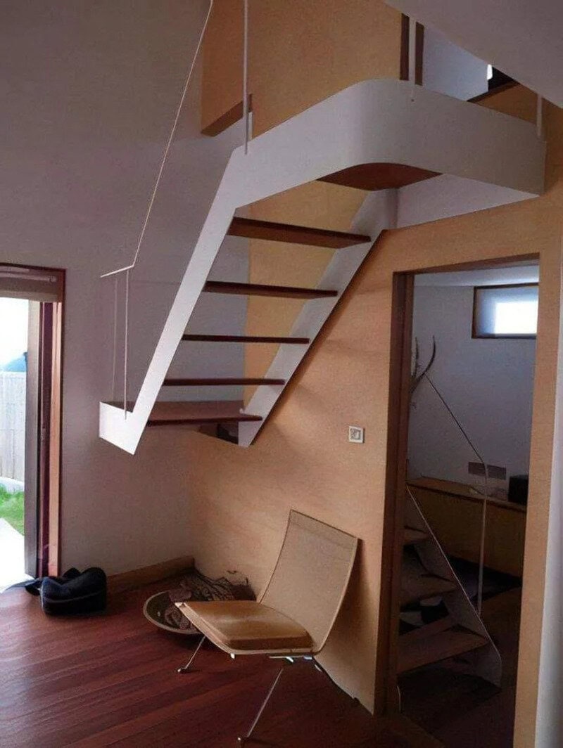 Unique staircase with floating steps and curved design in modern home.