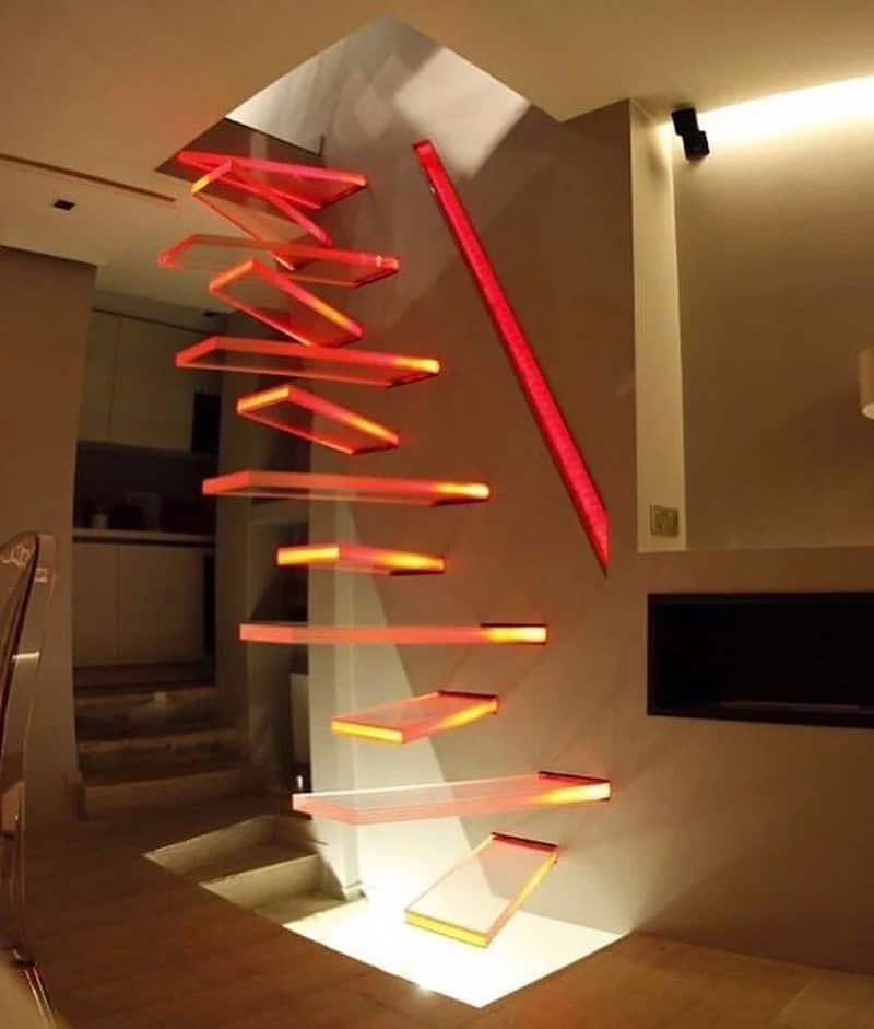 Unique staircase with zigzag red neon lights and floating steps in a modern interior.