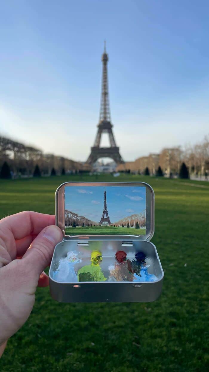 Eiffel Tower viewed through a smartphone with a miniature model of the tower inside the case.