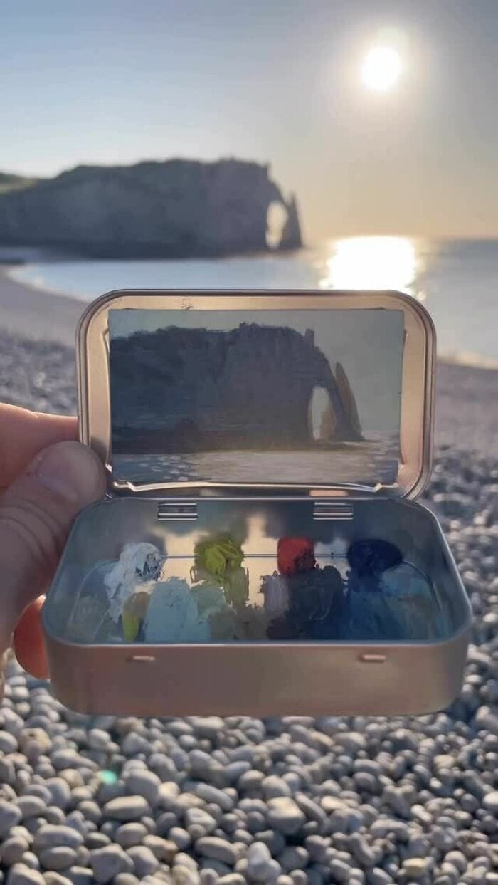 A beach scene with a jewelry box containing colorful rings and a smartphone capturing the view.