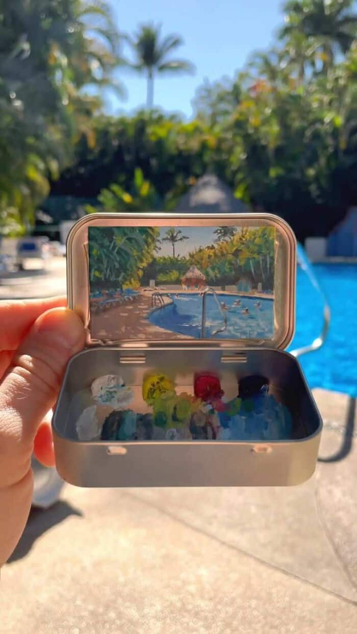 A colorful collection of small toys inside a transparent container with a pool and trees in the back.
