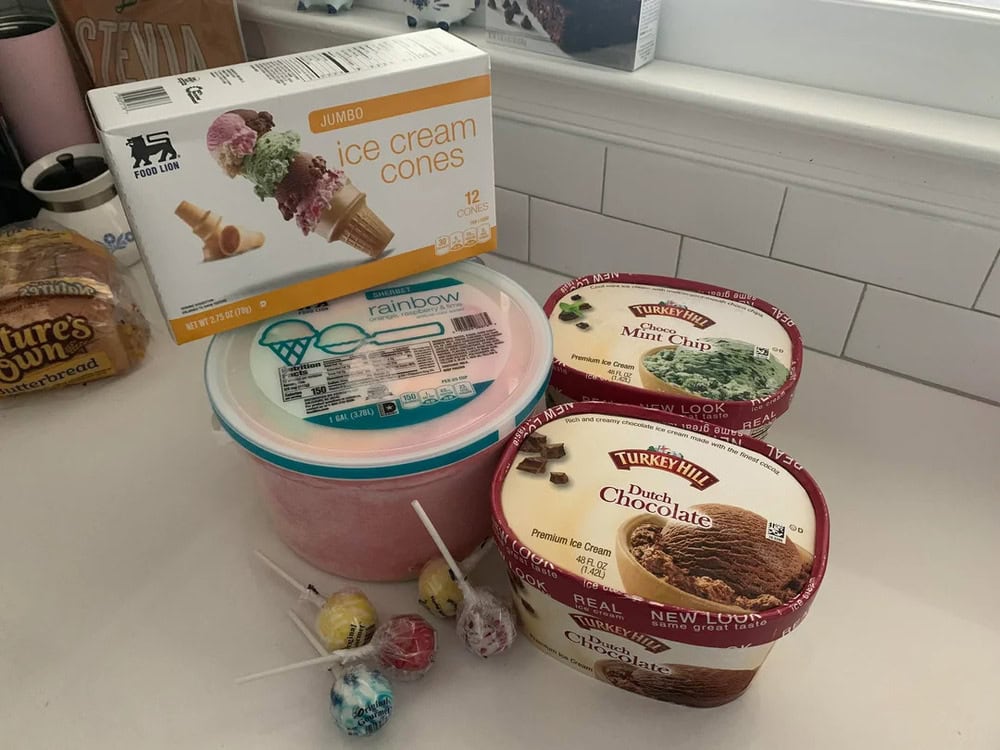 Jumbo ice cream cones box with ice cream and candy on a kitchen counter.