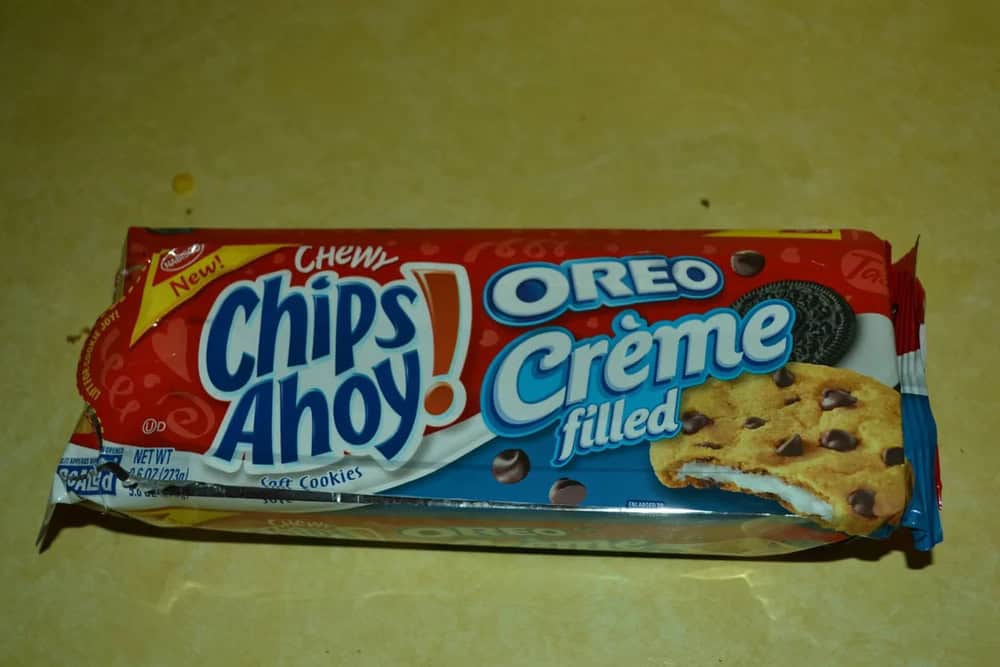 Chewy Chips Ahoy! Oreo Creme filled cookie package on a yellow surface.