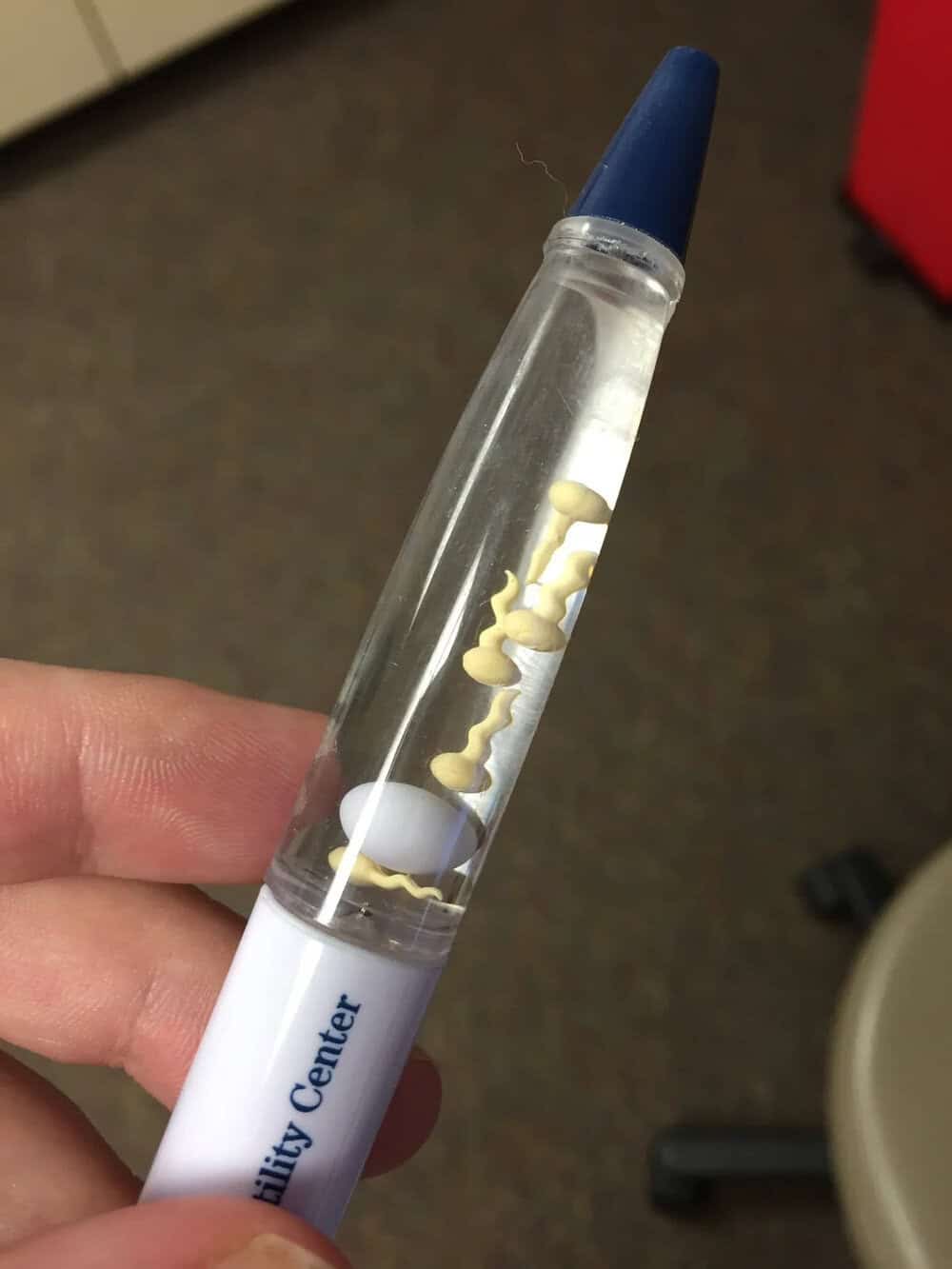 "Test tube with a blue cap and a white label reading 'Quality Center' containing a yellowish substan.