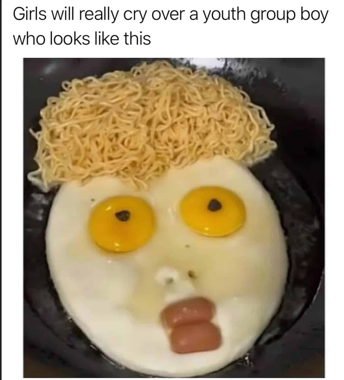 Eggs with two yolks resembling eyes, cooked noodles on top resembling hair, and a face made with egg.