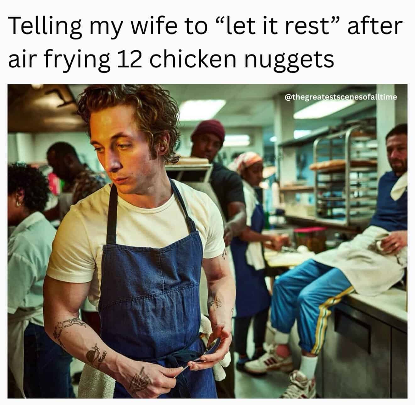 Man in a kitchen with a disappointed expression after cooking chicken nuggets.