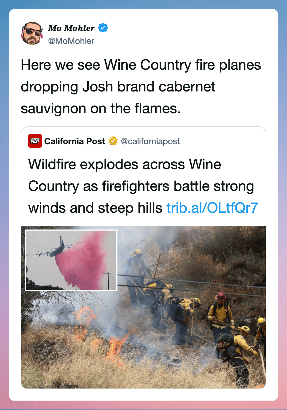 Firefighters battling wildfire with flames and smoke in a grassy area.