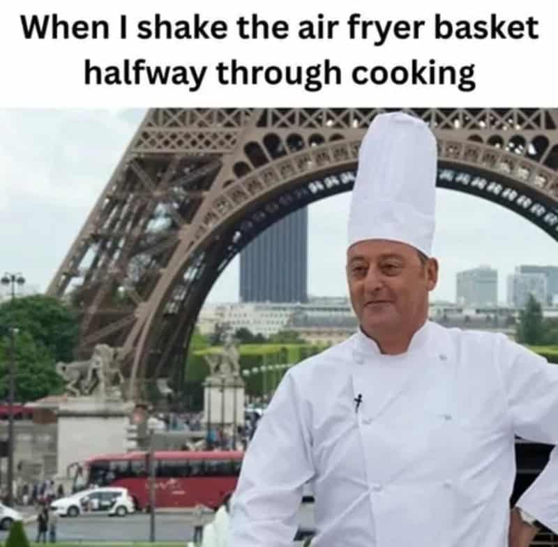 "Chef with a tall white hat in front of the Eiffel Tower in Paris, France.".