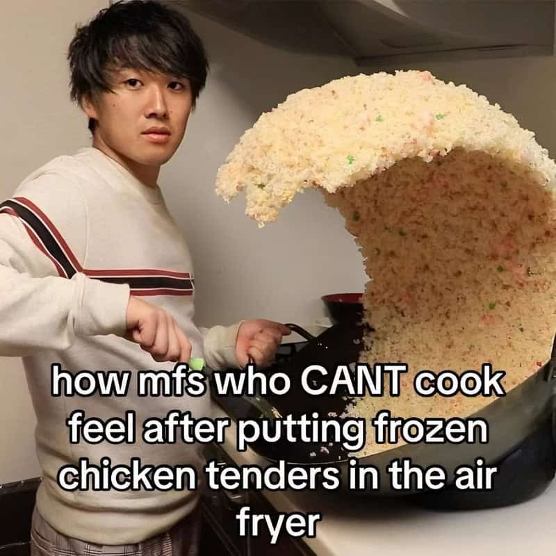 Person cooking frozen chicken tenders in air fryer with large puff of steam.