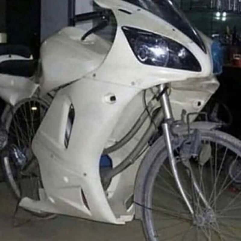 White motorcycle with black windshield and front headlight.