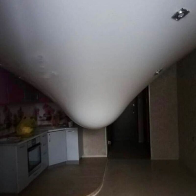Ceiling with a curved, smooth surface and recessed lighting fixtures.