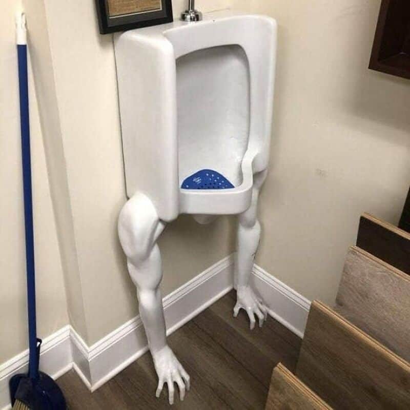 Unique urinal with animal legs and paws in a bathroom setting.