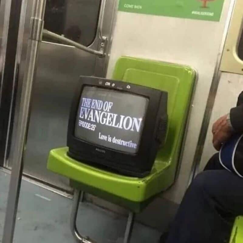"Love is destructive" displayed on a small TV screen inside a subway train.