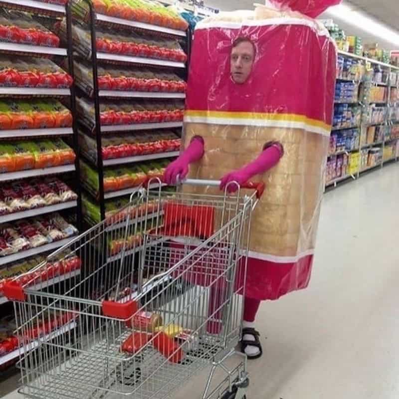 Person in a large ice cream costume shopping in a grocery store aisle.