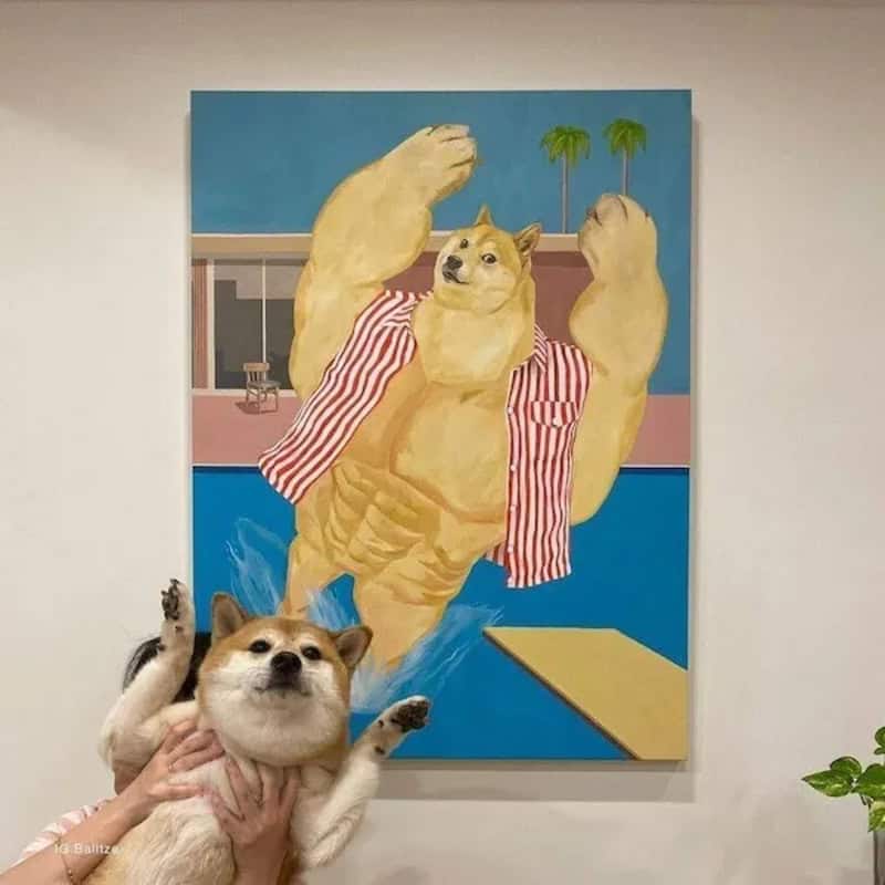 Dog in front of a painting of a muscular dog with palm trees.