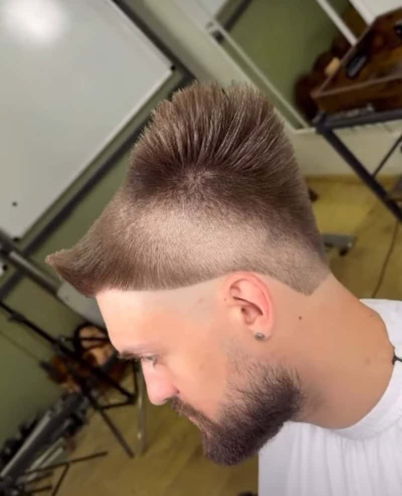 Side view of a man with a poorly executed mohawk haircut.