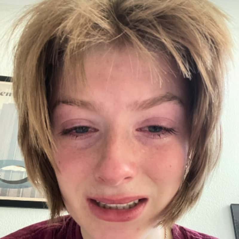 Person with messy, uneven haircut and a distressed expression.