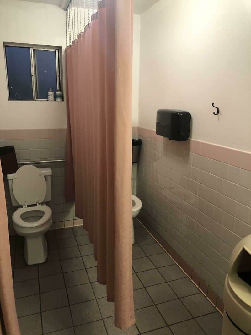 Bathroom with a privacy curtain separating the toilet from the rest of the room.