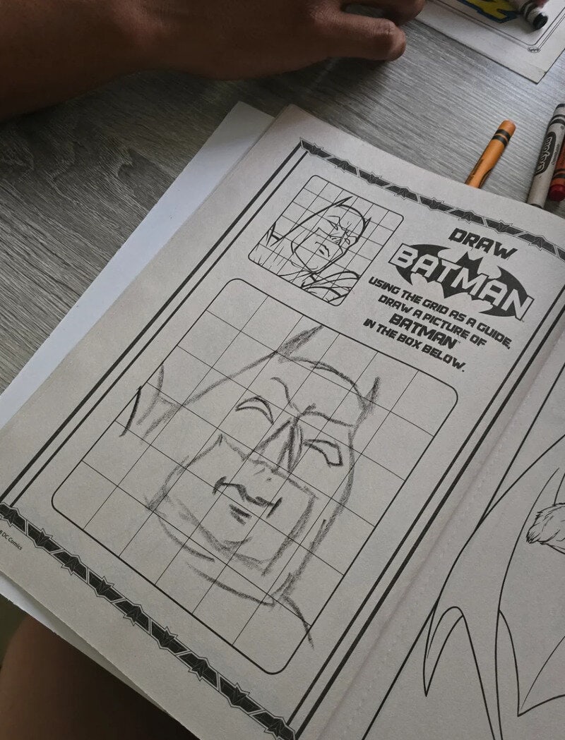 Step-by-step Batman drawing guide with grid and facial sketch.