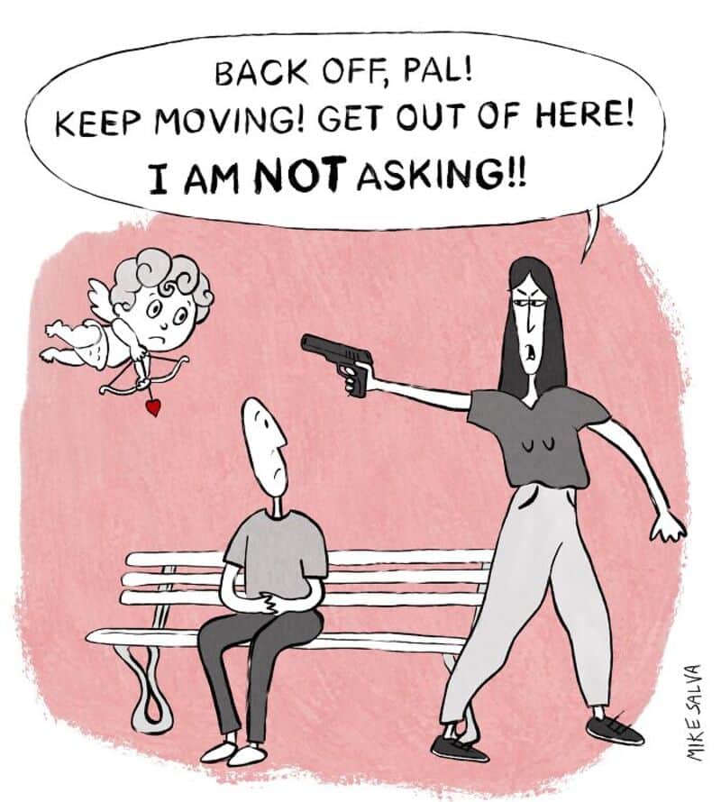 Woman pointing a gun at a seated man, shouting commands.