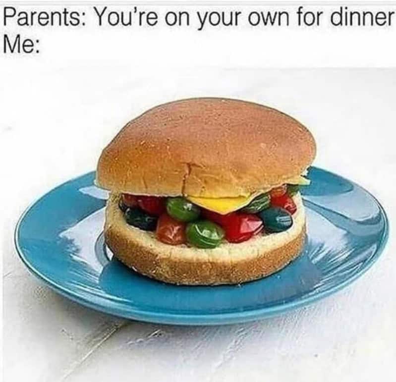 A burger with jelly beans on a blue plate, with text about dinner plans.