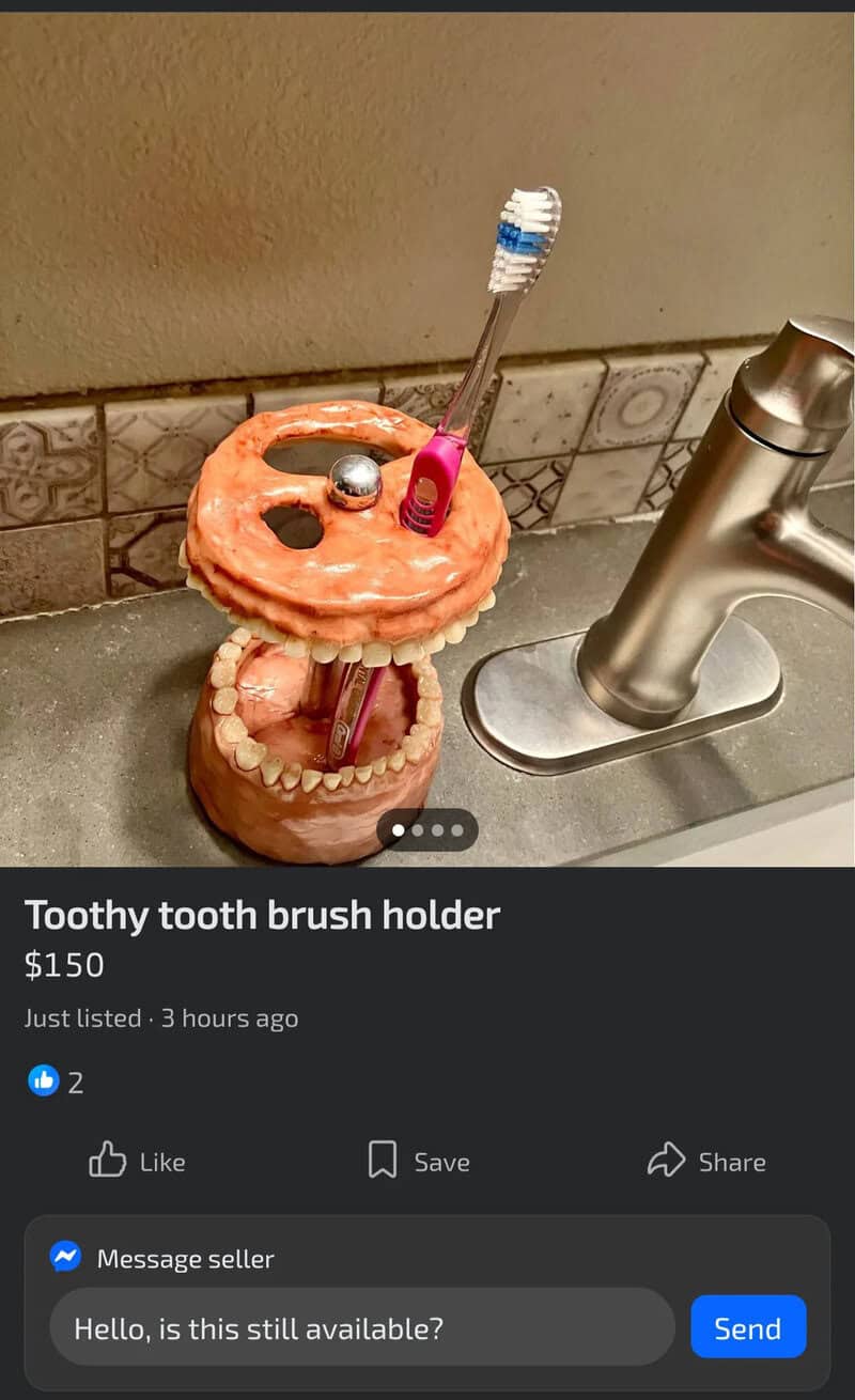 Toothy tooth brush holder with a toothbrush, placed on a bathroom sink.