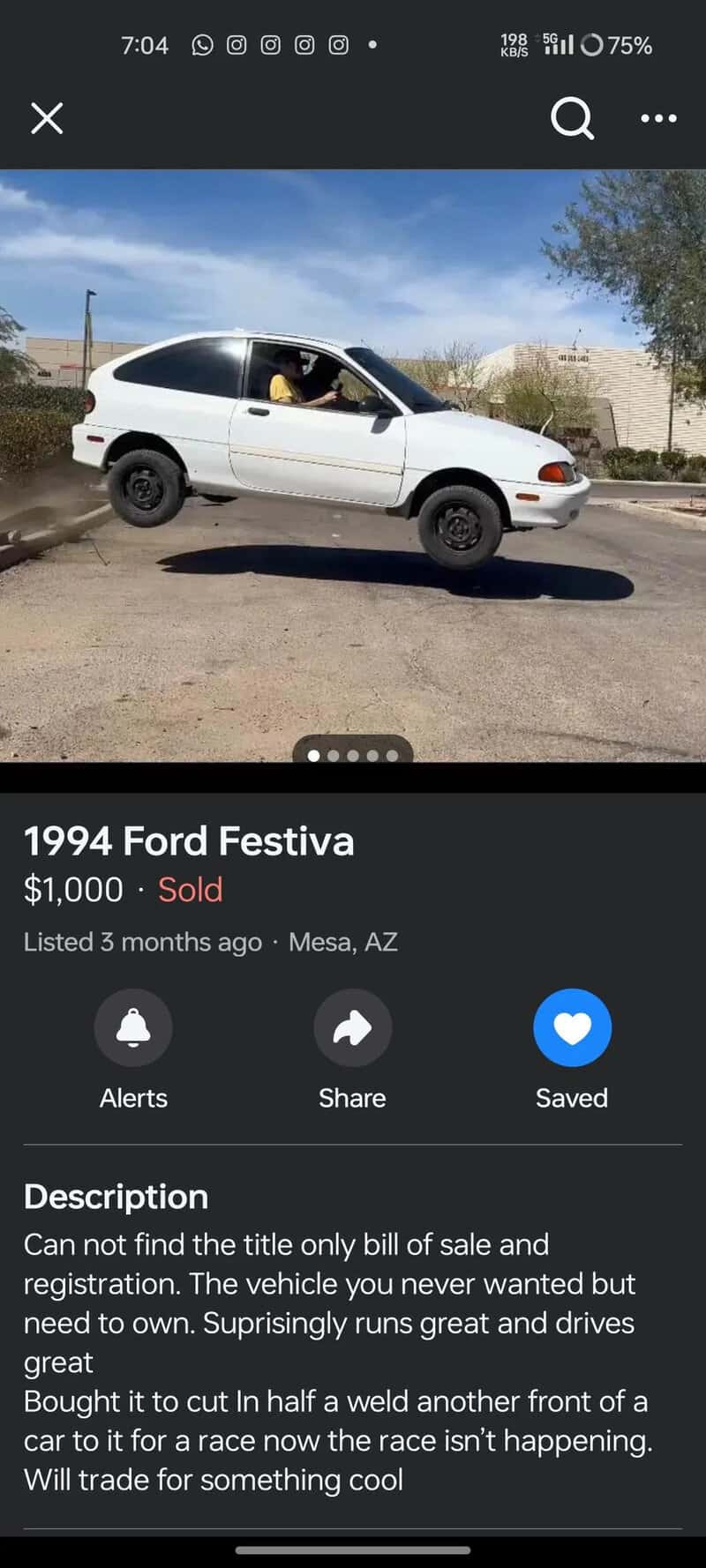 1994 Ford Festiva white car with a person inside, parked on the street.