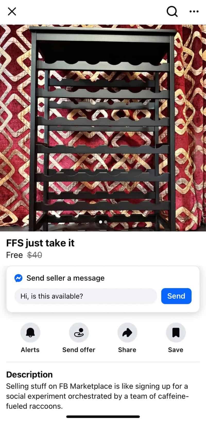 Black wine rack with multiple shelves in front of a patterned red and gold curtain.