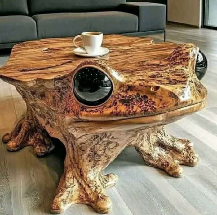 Unique wooden table resembling a frog with a cup and saucer on top.
