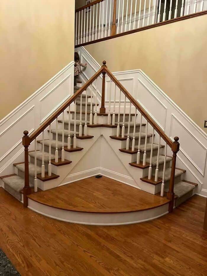 Custom-built staircase with curved landing and wooden handrails.